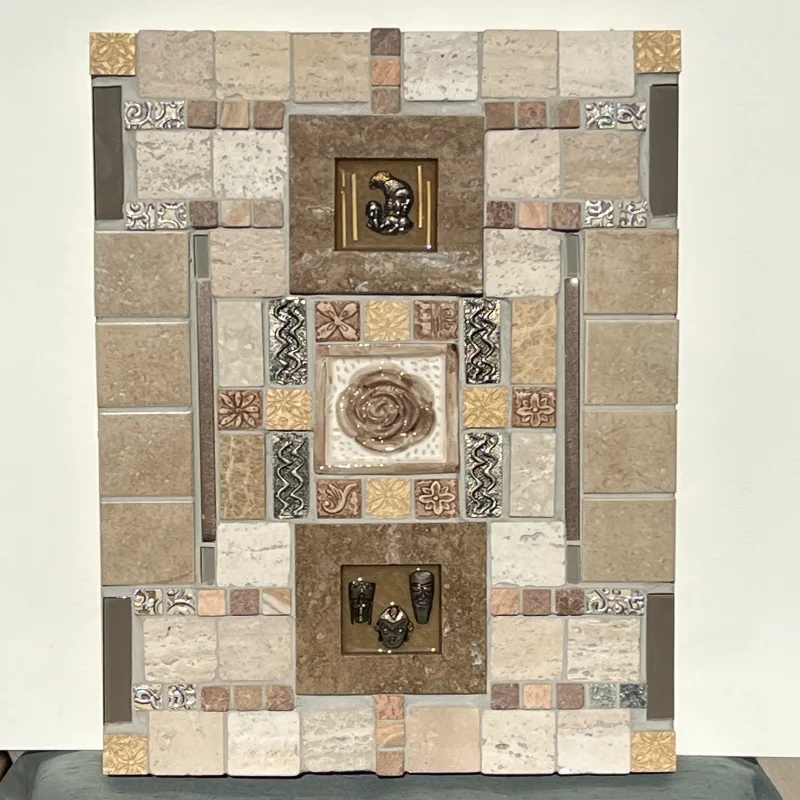 Handcrafted ceramic tiles in beiges and browns create a tactile surface that plays with light and shadow.