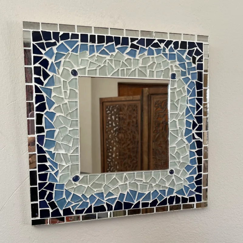 Shades of blue and mirror pieces create a border that dances with light, like sunlight on waves.